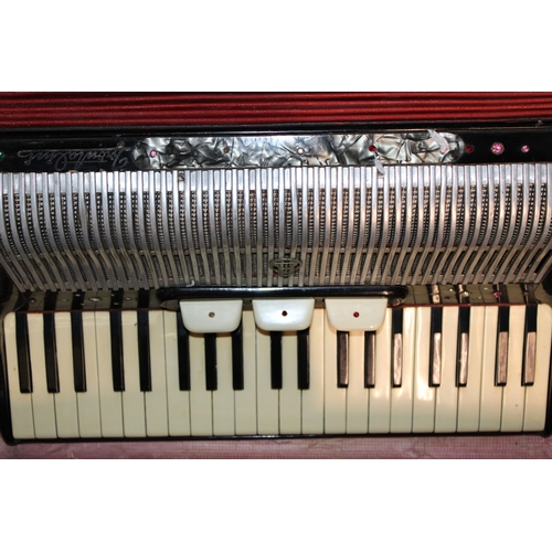 277 - A vintage accordion in original case. Width 57cm height 26cm.