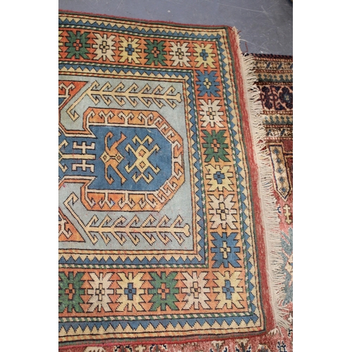 284 - A Turkish hand knotted carpet in pale blue, blue, oranges and reds. 104cm x 162cm