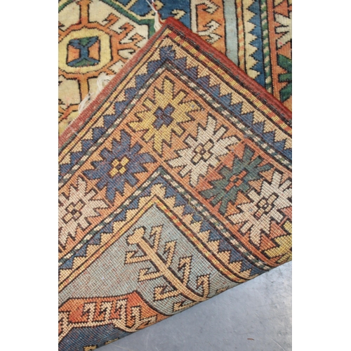 284 - A Turkish hand knotted carpet in pale blue, blue, oranges and reds. 104cm x 162cm