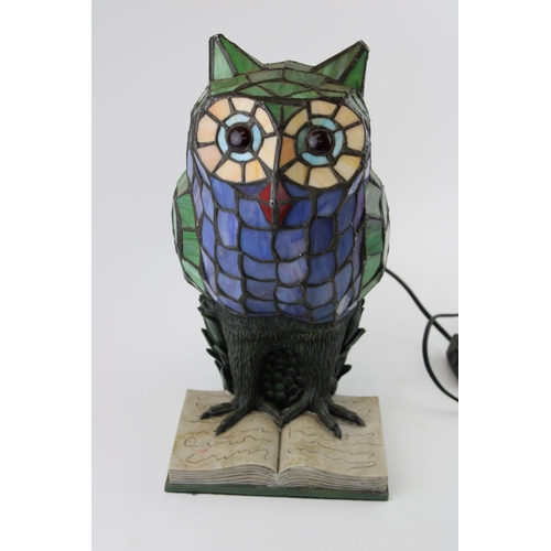 288 - A Tiffany style lamp in the form of an owl sitting on a book. Height 34cm.