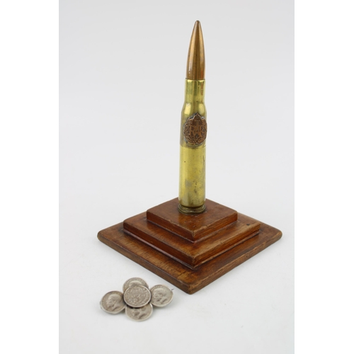 298 - A trench art lighter mounted on a plinth with RAF emblem (Height 17cm) together with a brooch made o... 