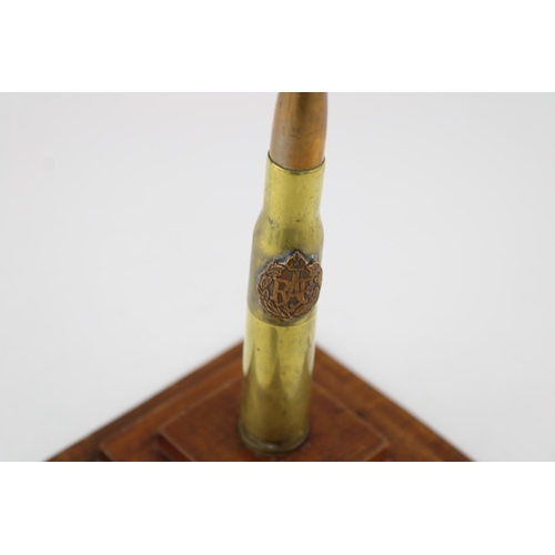 298 - A trench art lighter mounted on a plinth with RAF emblem (Height 17cm) together with a brooch made o... 