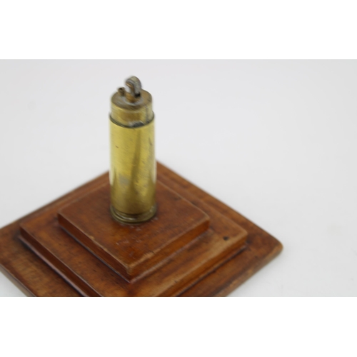 298 - A trench art lighter mounted on a plinth with RAF emblem (Height 17cm) together with a brooch made o... 