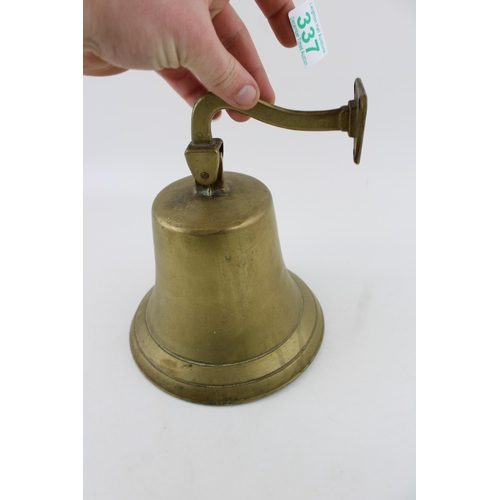 337 - Vintage cast metal bell, wall mount, with clanger, 19cm tall.