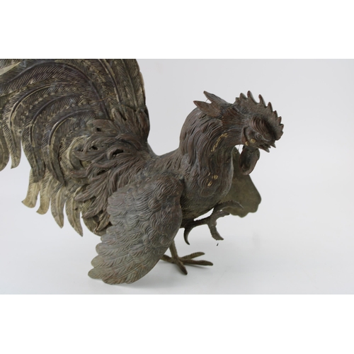 338 - A cast metal sculpture of a fighting cock / of cock fighting interest. Height 38cm.