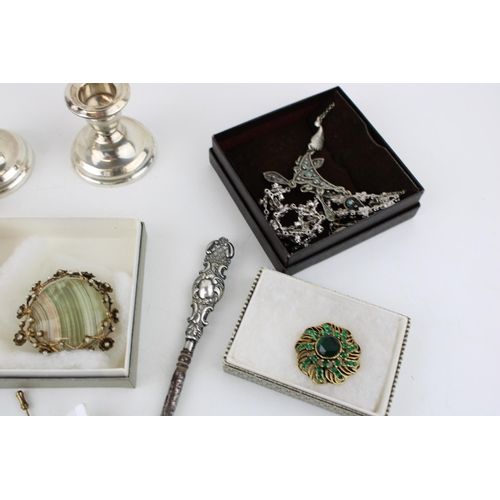 358 - A collection of Silver hallmarked items including a pair of candlesticks, button hook, a caddy spoon... 