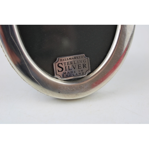 360 - A sterling silver oval photo frame hallmarked Sheffield 1991. Concorde Aeroplanes. Height 11cm