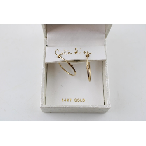 369 - A pair of 14ct yellow gold hoop earrings by Cote d'ai. Hoop diameter 18mm. Weight 0.5g.