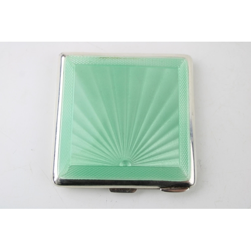 395 - Art Deco silver compact with green enamel decoration, Birmingham 1922, 90.0g.