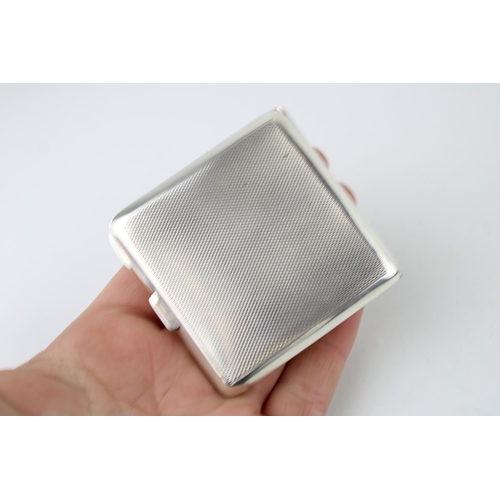 395 - Art Deco silver compact with green enamel decoration, Birmingham 1922, 90.0g.