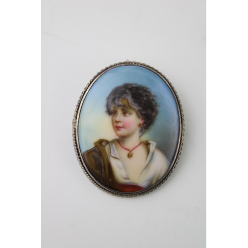 414 - A miniature painted portrait in silver mount brooch, 54mm tall.