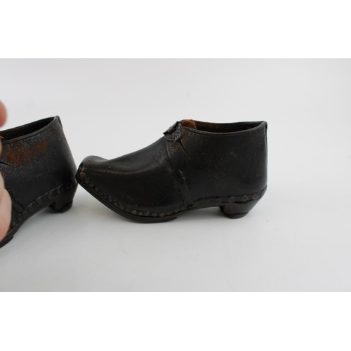 423 - A pair of Victorian leather and wooden clogs, suitable for children (2).