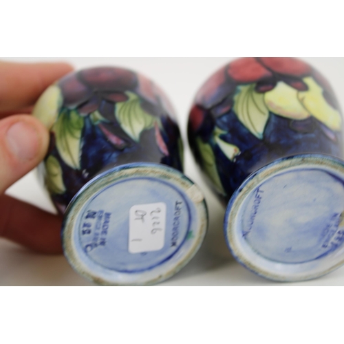 60 - Two Moorcroft Wisteria Plum vases, both chipped, 9.5cm tall.