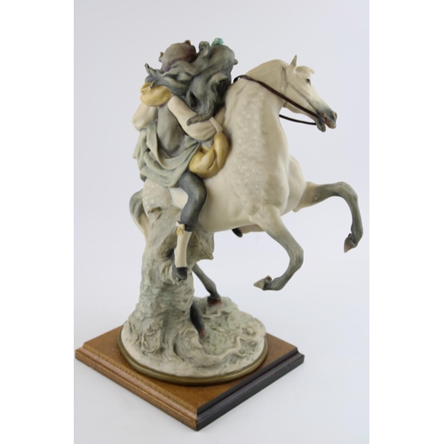 75 - Florence Giuseppe Armani Figurine of a romantic couple on rearing horseback, 37cm tall, wooden base.