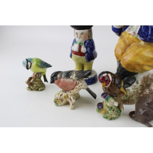 88 - A collection of ceramic items to include two 19th century lidded Toby Jugs, Beswick birds, 922 Blue ... 