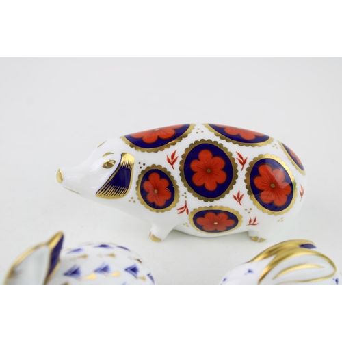 118 - A collection of Royal Crown Derby paperweights to include a pig and two rabbits. Height 7.5cm. (3)