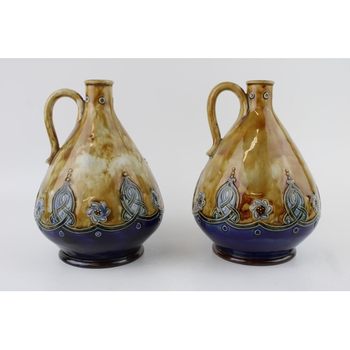 145 - A near pair of Royal Doulton Stoneware flagons, Art Nouveau form, curved handle, '1365' impressed (2... 