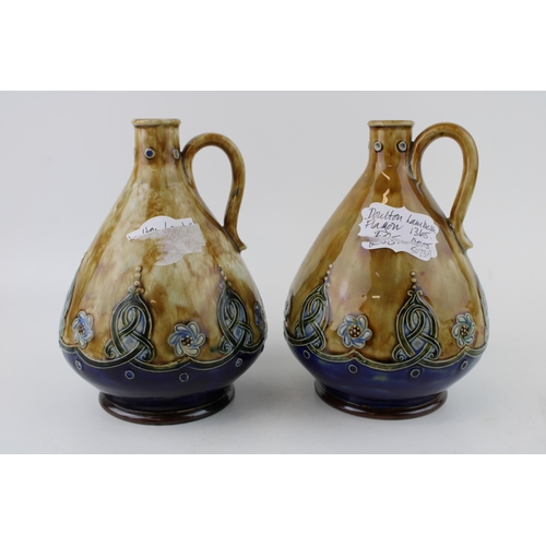 145 - A near pair of Royal Doulton Stoneware flagons, Art Nouveau form, curved handle, '1365' impressed (2... 