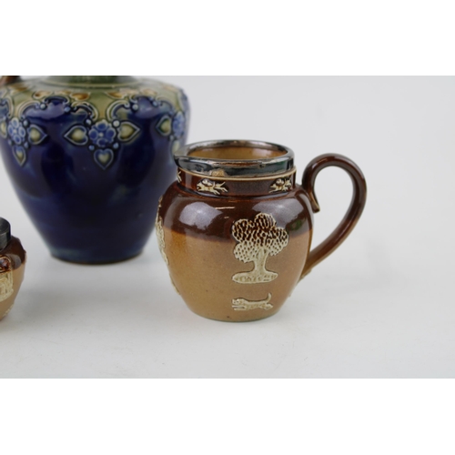 146 - Two Doulton Lambeth items to include a cruet and a jug, both silver rimmed, with a Royal Doulton sto... 