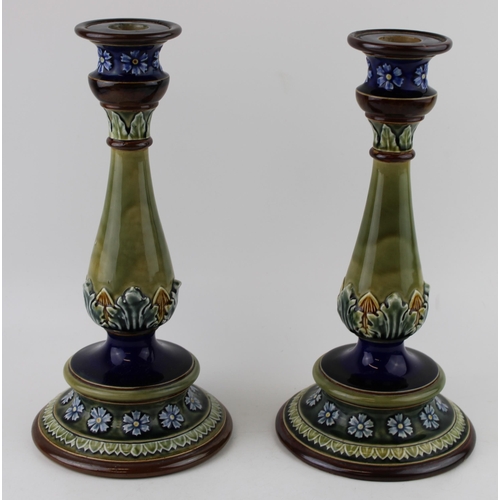 155 - A pair of Doulton Lambeth large candlesticks, floral relief, 29.5cm tall (2 - 1 rim af).