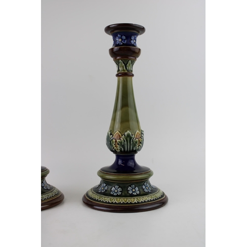 155 - A pair of Doulton Lambeth large candlesticks, floral relief, 29.5cm tall (2 - 1 rim af).