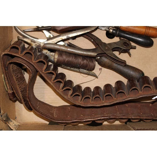 319 - A collection of vintage leather workers tools together with a vintage leather cartridge belt. (Qty)