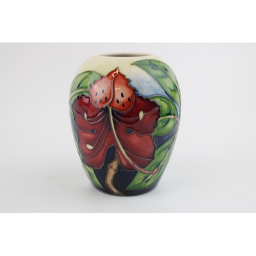 41 - A Moorcroft pottery squat vase in the 'Simeon' pattern. Height 9.5cm.