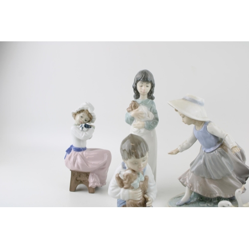 46 - A collection of Nao figures to include a boy with his dog, a girl with a dog seated and others (7).