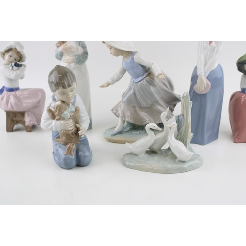 46 - A collection of Nao figures to include a boy with his dog, a girl with a dog seated and others (7).