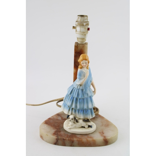 71 - A soapstone lamp base with ceramic figure of lady with dog. Height 28cm.