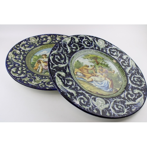 75 - A pair of 19th Century Italian Faience ware chargers, in the manner of Cantagalli, each with a mythi... 