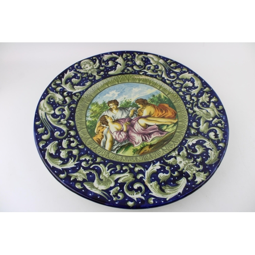 75 - A pair of 19th Century Italian Faience ware chargers, in the manner of Cantagalli, each with a mythi... 