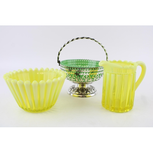 98 - A collection of uranium glass to include a yellow glass bowl and jug, with a silver plated bon bon d... 