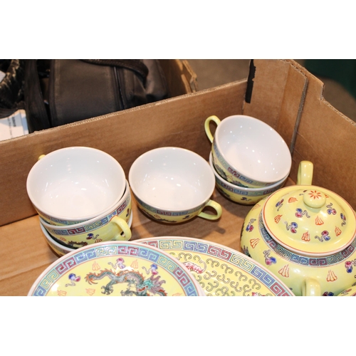 257 - A collection of tea and dinner ware in the 'Chinese Dragon Yellow' pattern to include tea pot, cream... 