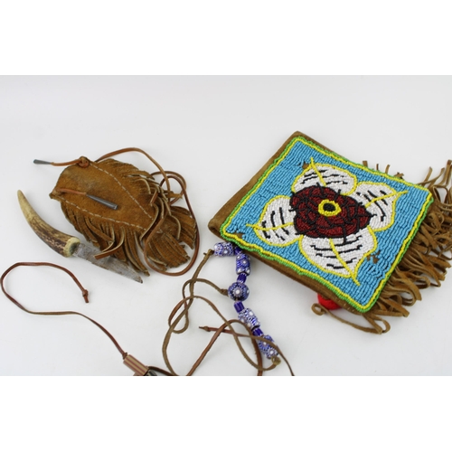 293 - Three items of North American Indian suede leather and beadwork including two pouches and a knife sh... 