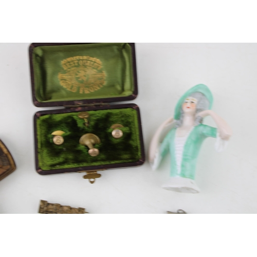 295 - A collection of items to include a ceramic pin doll, a snuff box, a pair of medals, a military cap b... 