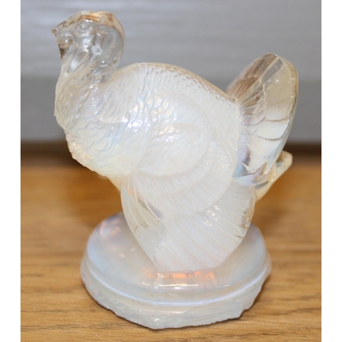 297 - Lalique opalescent figure of a turkey, circular base, signed to base, 6cm tall.