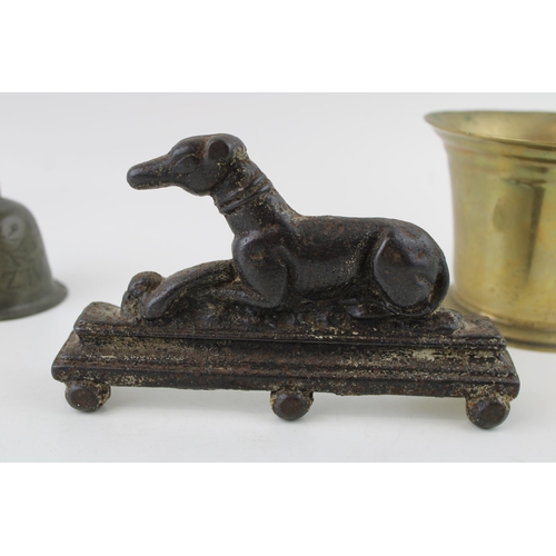 321 - A collection of metalware items to include a 19th cast iron door stop in the form of a sight hound t... 