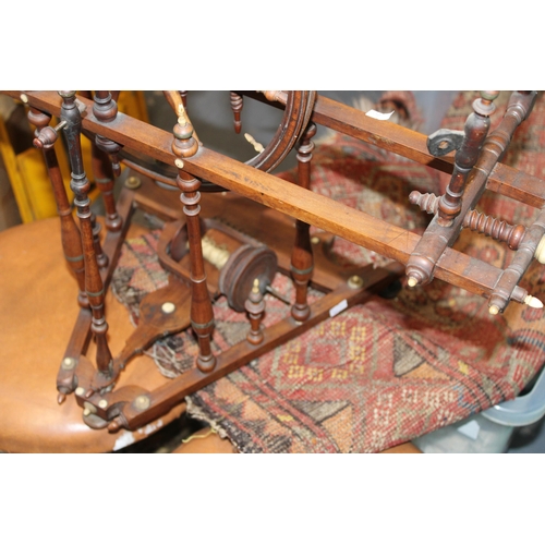 340 - A late 19th / early 20th century spinning wheel with seven spoke wheel and bone finials. Height 59cm... 