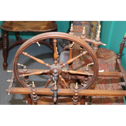 340 - A late 19th / early 20th century spinning wheel with seven spoke wheel and bone finials. Height 59cm... 