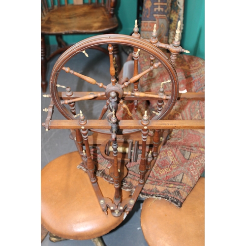 340 - A late 19th / early 20th century spinning wheel with seven spoke wheel and bone finials. Height 59cm... 