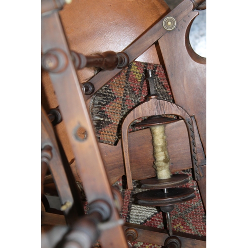 340 - A late 19th / early 20th century spinning wheel with seven spoke wheel and bone finials. Height 59cm... 