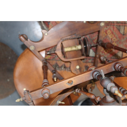 340 - A late 19th / early 20th century spinning wheel with seven spoke wheel and bone finials. Height 59cm... 