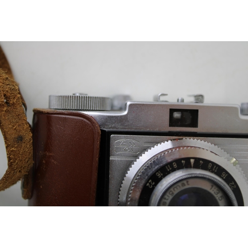 447 - A vintage Zeiss Ikon CONTINA 1a 35mm Camera, Novar 45mm 3.5 in original leather case with Boots KL-7... 