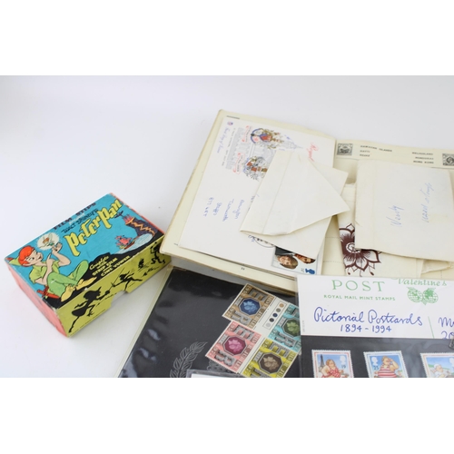 454 - A stamp album with a set of first day cover together with a peter pan viewer, a spoon set and two so... 