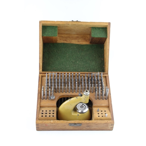 547 - An oak cased vintage watchmakers, Jeweling tool set / staking set. Height 12cm.