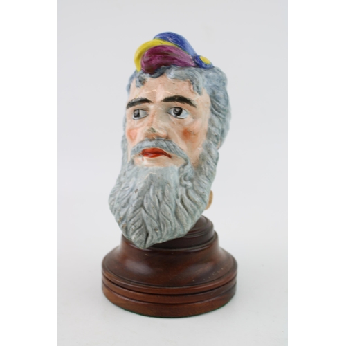 56 - An early 20th century pottery bust of a gentleman, similar to Bacchus, unmarked, wooden plinth, 20.5... 