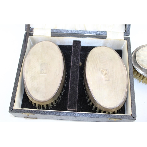 561 - A collection of silver brushes to included a cased example hallmarked Birmingham 1967 (inscribed wit... 