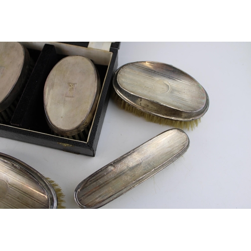 561 - A collection of silver brushes to included a cased example hallmarked Birmingham 1967 (inscribed wit... 