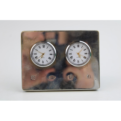 563 - Hallmarked silver front mantle clock, two faces, easel back, London 2002, 10.5cm wide.